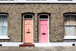 two-brick-houses-with-pink-doors